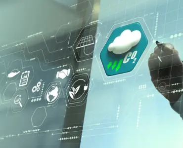 A person is using a transparent, futuristic touchscreen display featuring weather icons and data readouts